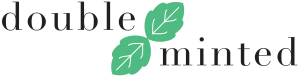 double minted logo with images of two mint leaves between the words