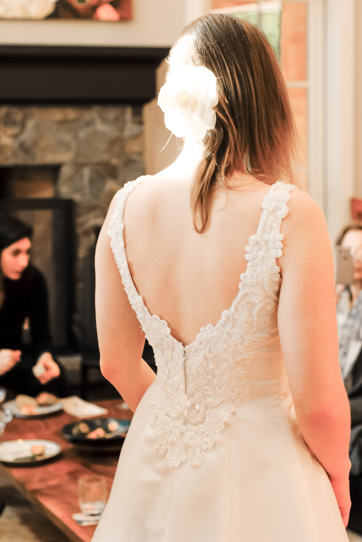 Close up on the beaded back of a satin wedding dress