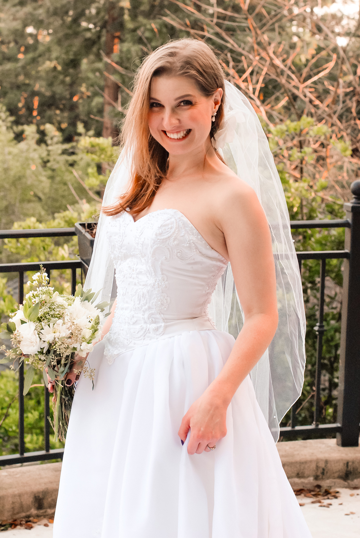 Devon smiling wearing a beaded ballgown wedding dress