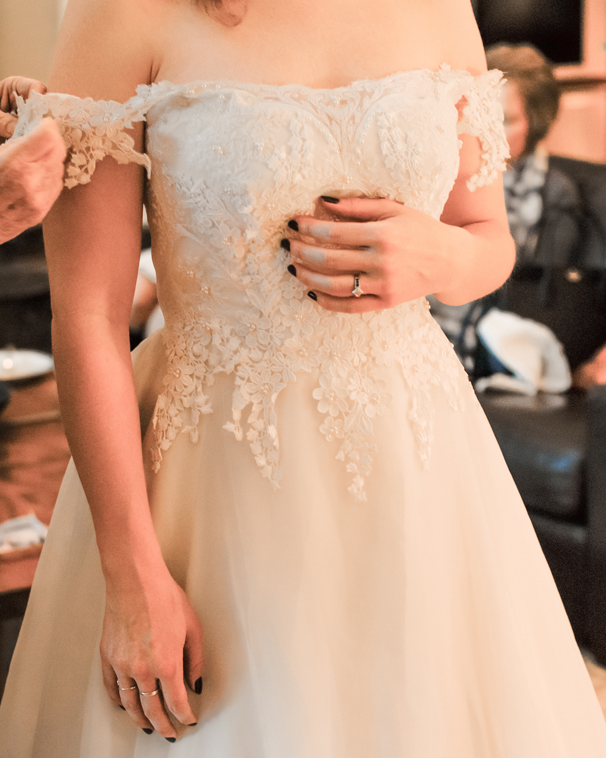 Closeup of a chiffon wedding dress with a lace applique bodice